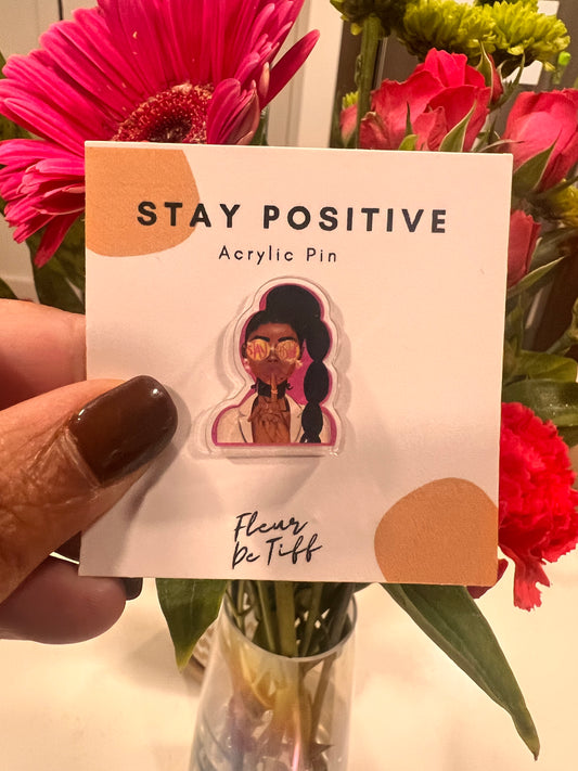 A stylish and empowering acrylic pin featuring the intricate illustration of a confident Black woman. The design showcases cultural pride, beauty, and strength, with rich details in hair, attire, and expression, making it a statement accessory for self-expression and celebration of diversity